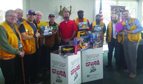 Contributed photo Bay City Lions Club members show off a collection box for the “Toys For Tots” campaign at businesses around the county. Lion's members brought toys to their meeting to donate. The Lions club also donated $500 to the campaign.