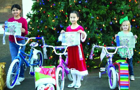 Sentinel photo/MaLinda Reddell This year's Sentinel Christmas Coloring Contest winners are from left, Alexa Rubio, Nadia Flores, and Allie Schneider. Each girl received a bicycle, a blue ribbon for their artistry, and a Christmas bag and stocking full of candy and other treats.