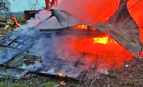 Dan Shook photo A firefighter battles a blaze that destroyed a trailer house in Van Vleck Jan. 15. A faulty space heater was given as the probable cause. 
