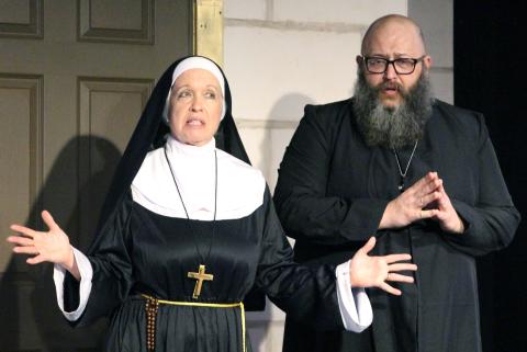Sentinel Photo/Jessica Shepard Mother Superior (Stacey Steiner), left, and “Father” Paul (Clay Breeden), work out their plan to discover the secret reports a newly appointed nun will send to Rome in CAST’s “Drinking Habits” press night Thursday, March 6. 