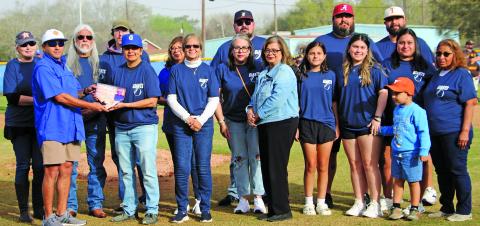 Sentinel Photo/Jessica Shepard Bay City Little League recognized Henry Charles for his years of support during the league's opening ceremony March 15. Little League President James Cadenas presented the Charles family with a plaque on the pitcher's mound.