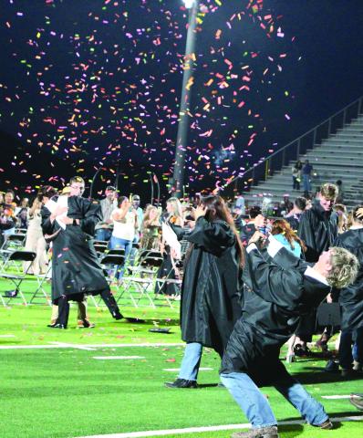 Sentinel Photo/Jessica Shepard Van Vleck graduates tossed their caps to celebrate their commencement, but one graduate had a more enthusiastic sendoff to high school Thursday, May 22.