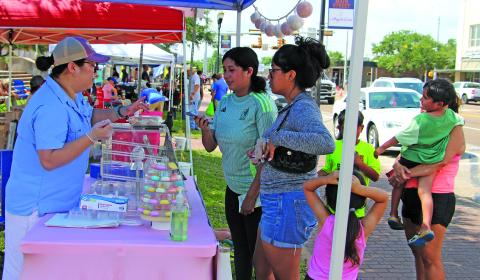 Sentinel Photo/Jessica Shepard Local bakery vendor "Kate's Delights" macaron cookies drew a crowd of customers during the Downtown Bay City Market Days event last Saturday. 