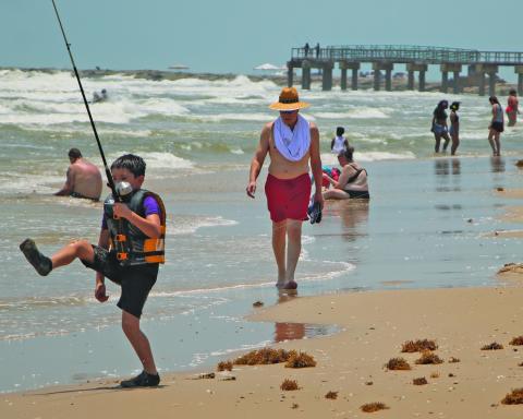 Sentinel Photo/Mike Reddell A young fisherman displays a different kind of fishing technique at Matagorda Beach last Saturday, May 24.