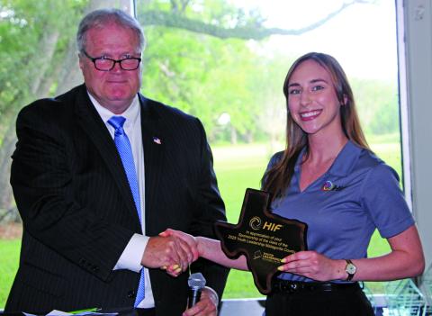 Sentinel Photo/Jessica Shepard County Judge Bobby Seiferman presented HIF USA Administrative Assistant Abigail Heisler with a recognition award at the Matagorda County Youth Leadership awards banquet on May 7. The award is for HIF USA’s continued program support for the second year in a row.