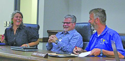 Sentinel Photo/Jessica Shepard New Bay City ISD Superintendent of Schools, Christopher Townsend, center, shared a laugh with BCISD Board President Jill Westmoreland, left, and Board Vice President James Scardami, right, June 10. 