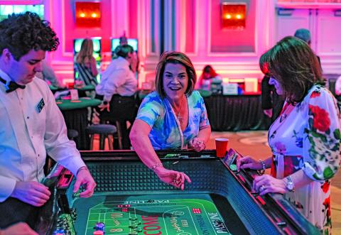 WCJC photo Michelle Bohreer of Bohreer Law Firm rolls the dice at the craps table at the second annual “Blackjack, Glitz & Glamor” fundraising event hosted by the Wharton County Junior College Foundation Saturday, May 31, at the Houston Marriott Sugar Land.