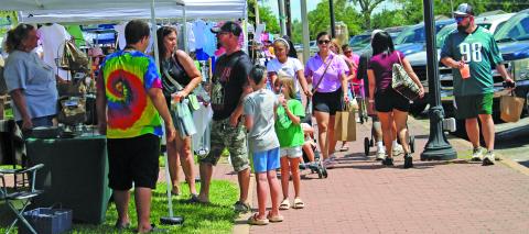 Sentinel Photo/Jessica Shepard Soaring summer temperatures didn't stop Downtown Market Day attendees, above, from viewing a variety of vendors and their wares on Saturday, June 28. 