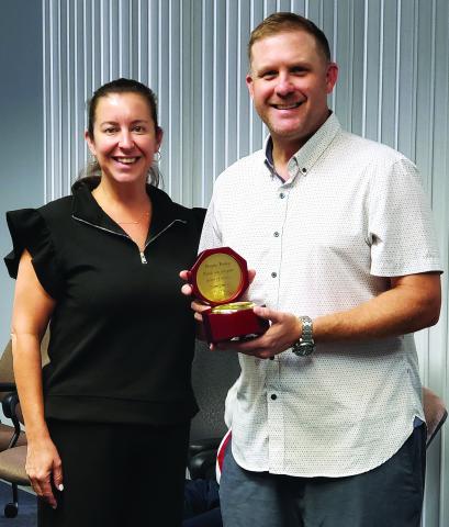 Sentinel photo/Jessica Shepard Bay City Community Development Corporation (BCCDC) recognized former board member Blayne Finlay, right, for his commitment and service while on the board during their monthly meeting Monday, June 30. BCCDC Executive Director Jessica Russell, left, gifted Finlay with a clock on behalf of the board.