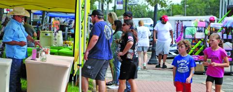 Sentinel Photo/Jessica Shepard A colorful array of vendors enticed customers to brave the heat and rain during Downtown Bay City Market Days on Saturday, July 26. The monthly event had food trucks, homemade wares, and everything in between for visitors and residents.