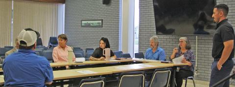 Sentinel Photo/Jessica Shepard City Engineering Technician Gabriel Lopez, right, presents a reimbursement request for a Cottonwood Park topographical survey at TIRZ #1 board meeting on Thursday, Aug. 21.