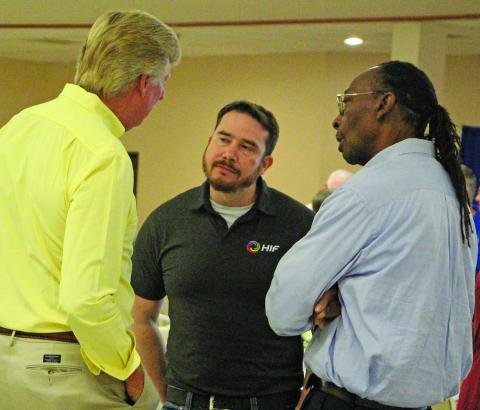 Sentinel Photo/Jessica Shepard HIF-USA Community Affairs and Permitting Manager James Outtrim, center, talks with Nate McDonald, left, and BCISD Trustee Kenneth Eaton during HIF's town hall luncheon Thursday, Sept. 18.