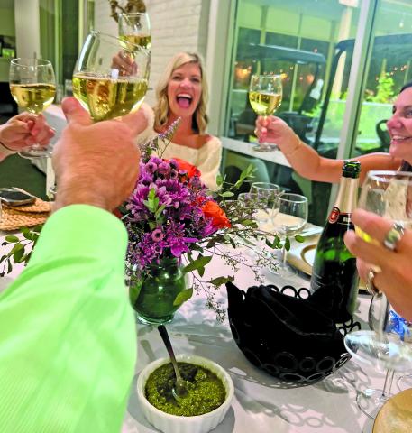 Courtesy photo Ashley Hagg joins others in a festive moment at Bay City Country Club’s French Champagne Dinner.