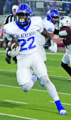Sentinel Photo/Mike Reddell Bay City back James Copeland (22) picks up yards and a block from junior center Koen Nunez (61) from en route to a game-high 245 yards rushing - and two touchdowns - against Floresville Friday.