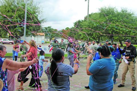 Sentinel Photo/Mike Reddell Bay City Police Department joined in a fun exchange of Silly String last week at the National Night Out at Bay City Library. Lots of city officials, BCISD officers and other agencies were part of this annual event. This part of National Night Out in Bay City - there were events at other Bay City  locations - were made possible “thanks to everyone who hosted, organized, and joined us,” said Police Chief Christella Rodriguez. 