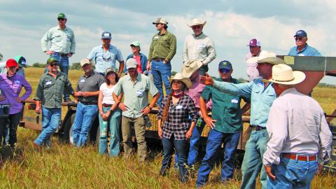 Sentinel Photo/Mike Reddell Adam Sneary, left, points to a pasture at the Sneary Cattle Ranch during a recent field day that covered topics such as different grazing management processes.