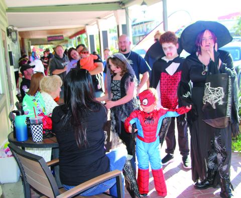 Sentinel Photo/Jessica Shepard Halloween brought scores of trick-or-treaters to downtown last Thursday. Above, a few of the youngsters’ costumes on display.