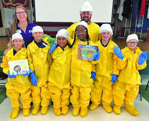 Contributed photo Holy Cross Catholic School’s 3rd, 4th and 5th grade students were at a presentation by the STP Nuclear Operating Company. The school thanked STP for educating students about the plants within the community and for the new books for the school’s library.