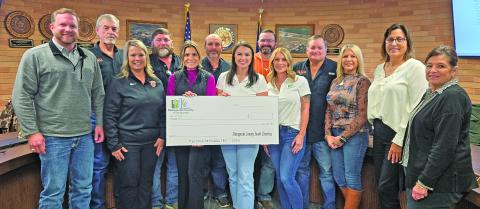 Sentinel Photo/Jessica Shepard Van Vleck ISD trustees join with others to show off the $2,000 donation from Matagorda County Youth Charities.