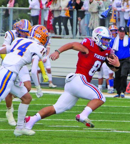 Sentinel Photo/MaLinda Reddell Senior Tiger quarterback Kale Russell (8) races away from Blanco defenders in the regional contest last Friday.