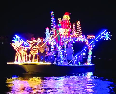 Photo/Bill Orton The Sargent Boat Parade had several entries and lots of appreciative residents watching along the Caney Saturday night.