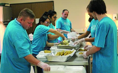 Sentinel Photo/Jessica Shepard Volunteers prepare to-go dinner plates at The Crisis Center's "18th Annual Chicken Fried Steak Dinner" fundraiser on Friday, Jan. 16. 