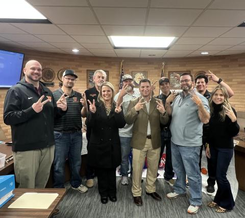 VVISD photo New VVISD Athletic Director and Head Football Coach Cody Carney (center right) joins Superintendent Christie Dement and trustees in flashing Leopard cheer symbol.