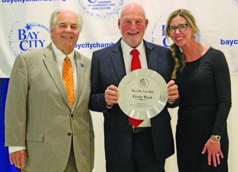 Sentinel Photo/Jessica Shepard Erwin Ward shows off his Man of the Year 2025 Award he received at the annual Bay City Chamber of Commerce and Agriculture Banquet Jan. 15. Outgoing chair John Dickerson and Chair-Elect Savannah Cornelius join Ward in the presentation.