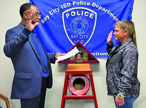 BCISD photo Bay City ISD Police Chief Leroy Cunningham administers the oath to new BCISD Officer Lacey Gilbert who has many years of law enforcement experience. 