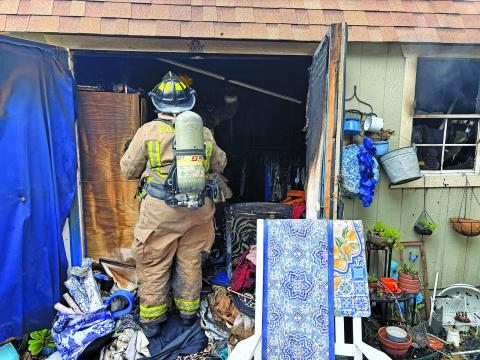 Contributed photo A Bay City firefighter checks the interior of a shed that caught fire.