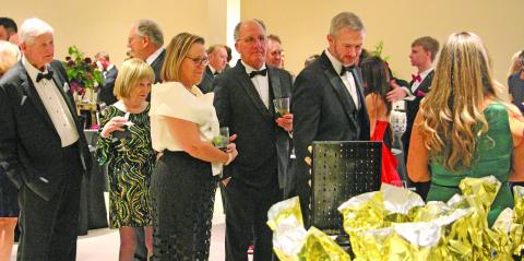 Sentinel Photo/Jessica Shepard Guests at the Junior Service League Charity Ball, Saturday, Feb. 7, form a line of prospective silent auction buyers.