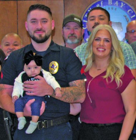 BCPD photo Newly promoted Bay City Police Department corporal Dillon Wakefield and his soulmate Angelyna introduce one of their three children at Wakefield’s recent promotion ceremony. 