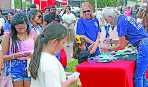 Sentinel Photo/Jessica Shepard Crisis Center officials are calling the 6th Annual Light Up the Square event Thursday, April 9, at the courthouse square the largest crowd ever. People of all ages joined in calling attention to Child Abuse & Sexual Assault Awareness. 