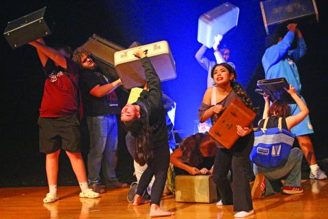 Sentinel Photo/Jessica Shepard During the "Anon(ymous)" opening sequence, BCHS Dungeoneers Madilynn Johnson and Sophie Jaramillo project the baggage of their respective characters on stage at the troupe's OAP rehearsal on March 25. 