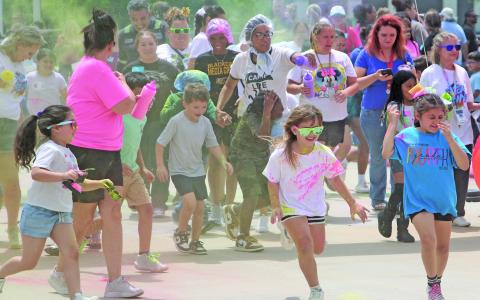 Linnie Roberts Elementary School students, parents, volunteers, and staff participated in the campus' annual "Color Run" event on Friday, April 17. Volunteers and staff showered students with colored powder every 15 minutes during the afternoon run. Some students even had their own respective bags of color to toss at each other as well as unsuspecting adults. Sentinel Photo/ Jessica Shepard
