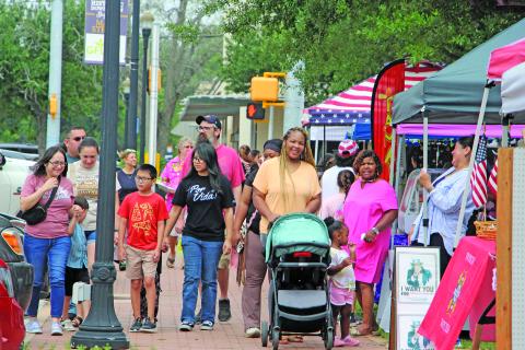 Sentinel Photo/Jessica Shepard Customers braved ominous skies, mosquitoes, and lovebugs to shop at Downtown Bay City Market Day on Saturday, April 25. Vendors showed off a variety of wares from homemade jams and jellies to indoor and outdoor decorations, along with several informational booths and food trucks.