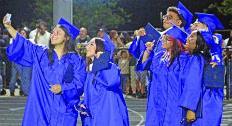 Sentinel Photo/Jessica Shepard New minted Bay City High School graduates get a group selfie at ceremonies Friday, May 22, at Memorial Stadium.
