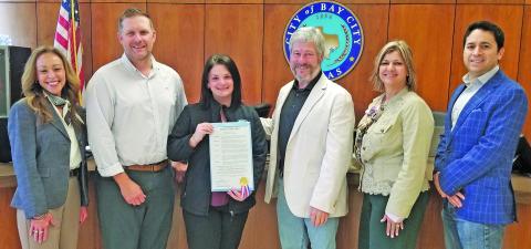 Sentinel photo/Mike Reddell A City Council proclamation last week designated the month of May as National Preservation Month. Main Street Director Tina Israel displays the document.