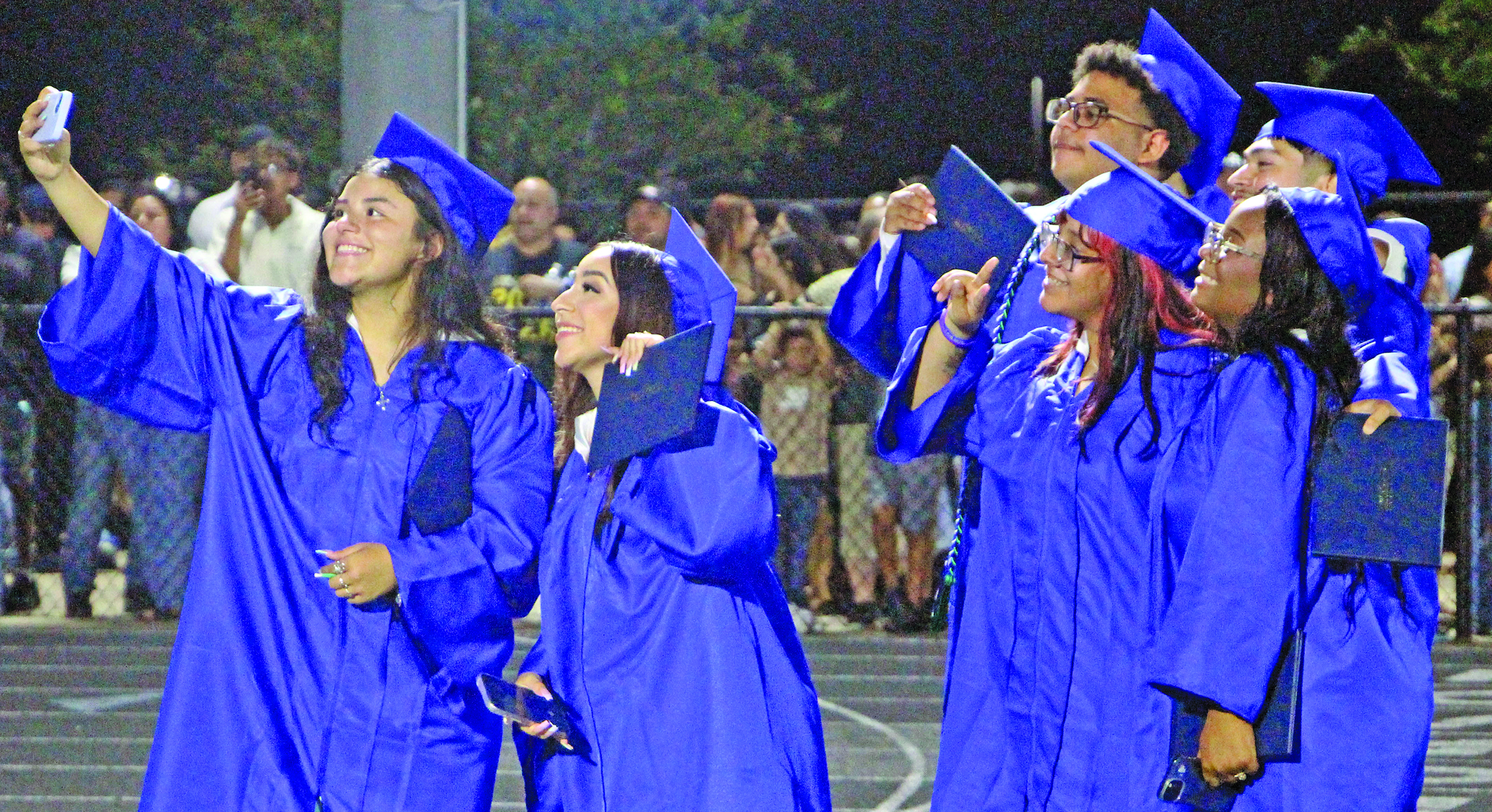 Sentinel Photo/Jessica Shepard New minted Bay City High School graduates get a group selfie at ceremonies Friday, May 22, at Memorial Stadium.
