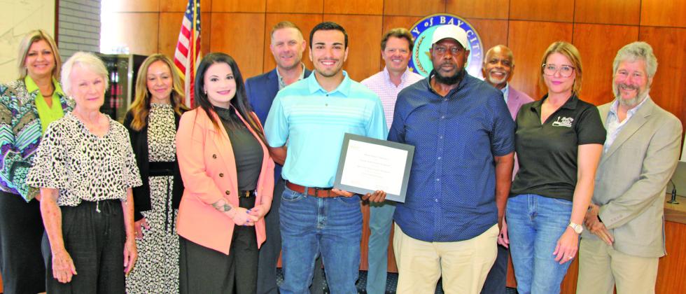 Sentinel Photo/Mike Reddell City Council joins Main Street board members in showing off a plaque recognizing Bay City Main Street as an Accredited Main Street America program.