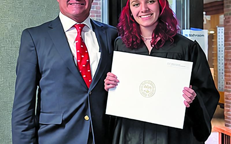 Courtesy photo Amber Michelle Simons and her father, Dr. Dane Simons, show off her recently awarded bachelor’s degree from Harvard University.