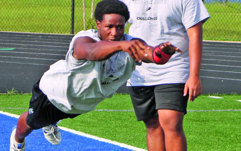 Sentinel Photo/Mike Reddell A Bay City Blackcat throws a medicine ball - a Lineman Challange event that tests upper-body strength and explosiveness.
