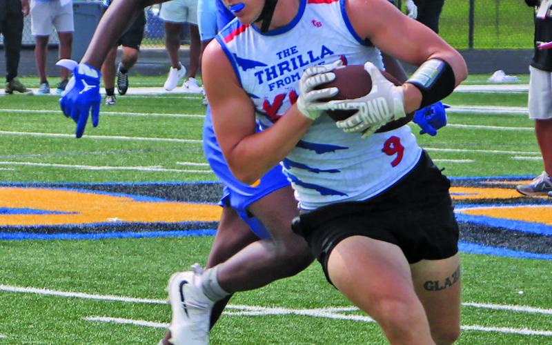 A Tidehaven runner tries to outdistance his Bay City defender in a 7on7 matchup last week during BCISD’s Kings of the South 7on7, Linemen Challenge last week at Memorial Stadium.  Sentinel Photo/Mike Reddell
