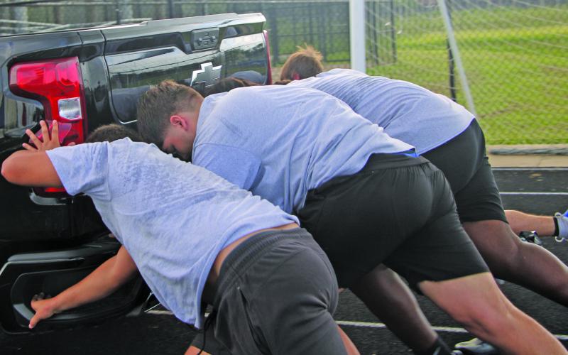 Sentinel Photo/Mike Reddell This foursome of Blackcats pushes a pickup truck as part of the Linemen Challenge event. The truck push is a well-known Linemen Challenge event throughout the country.