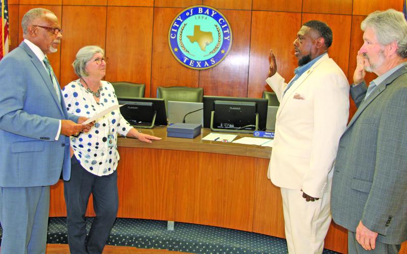 Sentinel Photo/Mike Reddell Shown from left, Bay City Mayor Robert Nelson, City Secretary Jeanna Thompson, and councilmen Corey McCray, and Jim Folse take part in swearing in ceremony last week.