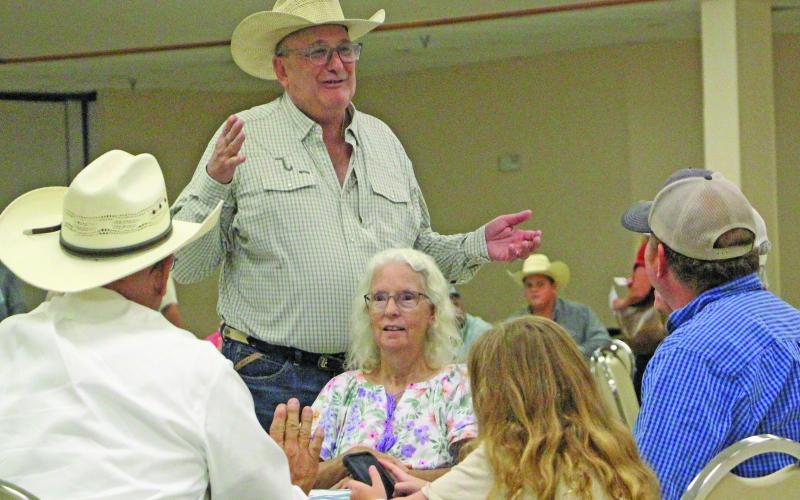 Sentinel Photo/Jessica Shepard Matagorda County Cattlemen's Association member George Harrison, standing, talks with several attendees at the MCCA's "New World Screwworm Seminar" on Thursday, June 25.