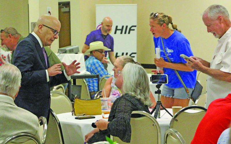 Sentinel Photo/Jessica Shepard HIF officials visited with audience members at the HIF meeting last week.
