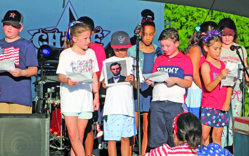 Sentinel Photo/Mike Reddell The Tenie Holmes Elementary Choir sang patriotic songs with illustrations of the nation’s leaders before a sizable crowd.