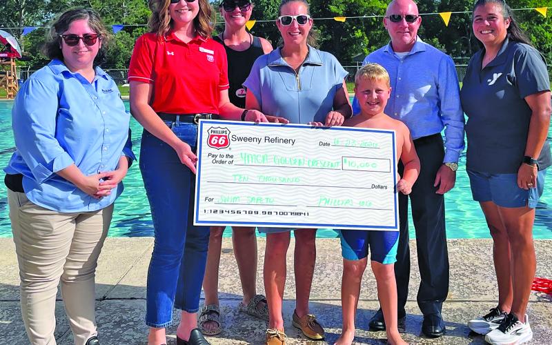 Phillips 66 photo Representatives from Phillips 66 and Bay City YMCA present $10,000 sponsorship check for the Phillips 66 Swim Safety Program.