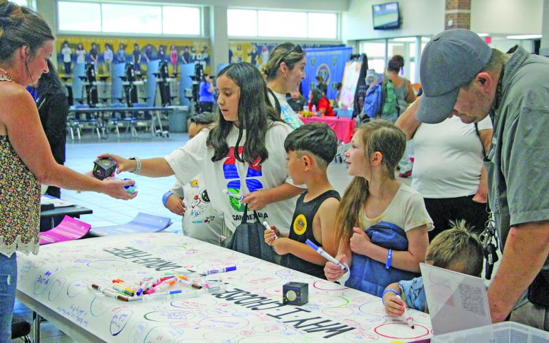 Sentinel Photo/Jessica Shepard Bay City ISD families participated in the district's annual "Back to School Bash" on Wednesday, July 29. While students were able to receive backpacks full of school supplies, guardians toured informational and community vendors at the Bay City High School campus. Other event features included health and dental screenings, games, prizes, bus rider information, and physicals with EKG testing.